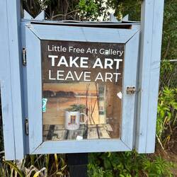 The "Take Art, Leave Art" booth outside the public library at Makawao.