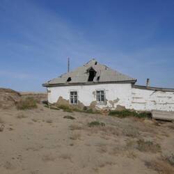 Families forced from village in mid-1980s. Children's toys still in the houses.
