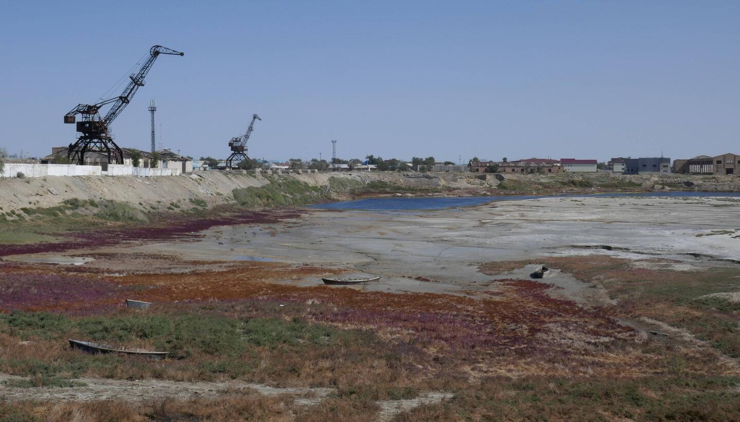 The empty harbour and redundant fishing cranes