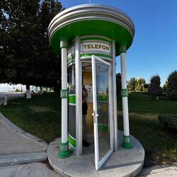 Telephone booth with a white phone