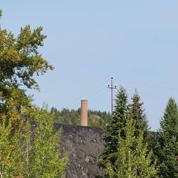 Stack from the old copper mine and huge piles of tailings