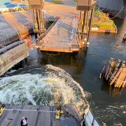 First Mate on vehicle deck guides the vessel to the docking locks, The shaped fender rack helps.