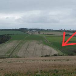 The red arrow points to the remains of a Roman road