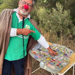 Angel pointing out his Alaska pin from a previous pilgrim.