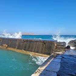 Waves crashing over the breakwall