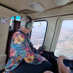 Angela in her fave spot. Gazing out the window of a chopper. It was bumpy i n the hot air