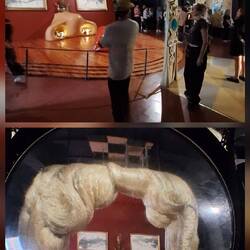 An optical illusion and the magnifying glass turns it into Mae West's face.