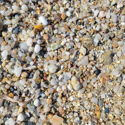 The grains of sand were small pieces of marble polished by the waves.