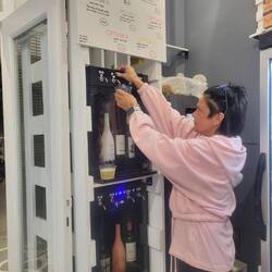 Mom demonstrating her wine dispenser. Lori wondered if she could get one for home.