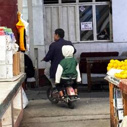 Scooters ride around in the market