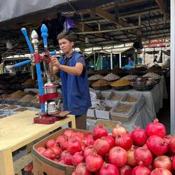 His job is to make pomegranate juice, and he's absolutely crushing it.
