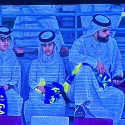 Father and sons enjoying a fútbol match