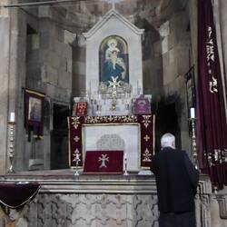 So much for 'simple' Armenian church - priest is on his cellphone. Must be calling God!