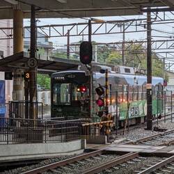 Train at level crossing by station