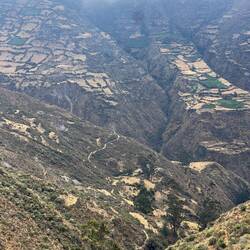 The steep slopes are terraced, the high mountains in the cloud