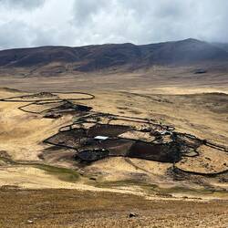 Crossing high plateau with isolated walled farms