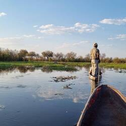 Out in the Mokoro. Relaxing to let someone else do the work. Its OK. The crocs are small.