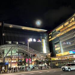 The almost full moon over Hakata station