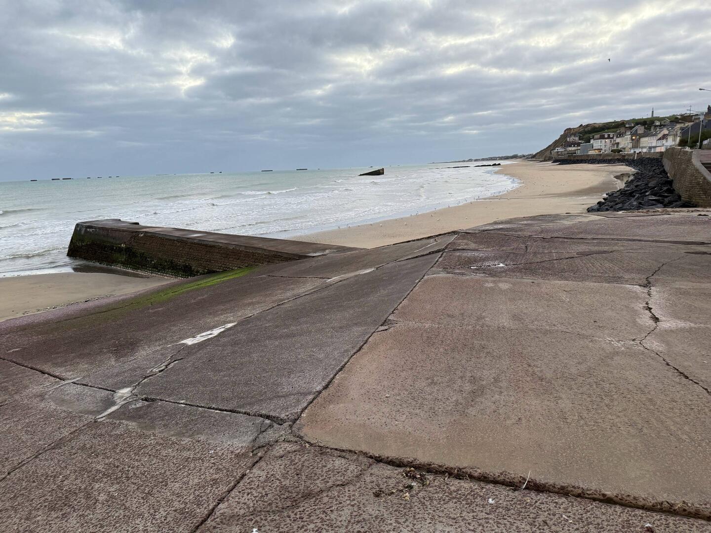 Arromanches and the remains of Port Winston, looking east. British memorial on the hill