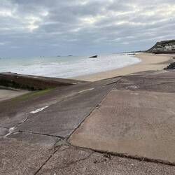 Arromanches and the remains of Port Winston, looking east. British memorial on the hill