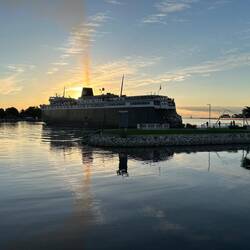 She's dropped her starboard anchor and is using it and her two engines to swing about