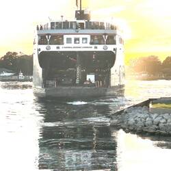 The captain has come to the stern wheelhouse to manoeuver into the berth