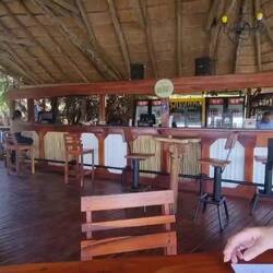The bar. It's not air conditioned except for the breeze along the river. Hard life.