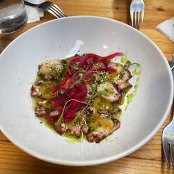 Poached octopus with sweet potato puree, olive oil, pickled onions