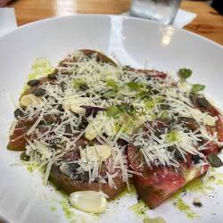 Cherokee tomato with hard cheese, tart vinaigrette and almonds and pumpkin seeds