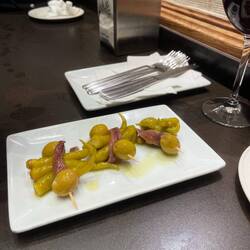Traditional tapas of olive, pickled pepper, anchovy