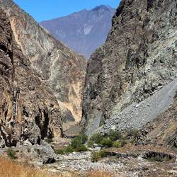 The road somehow finds its way between the walls of the cañon