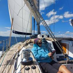 Catching up with the reading whilst calm at sea!