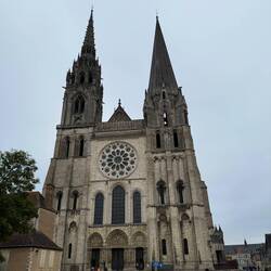 Simple 12th century steeple on the right, gothic 16th century one on the left
