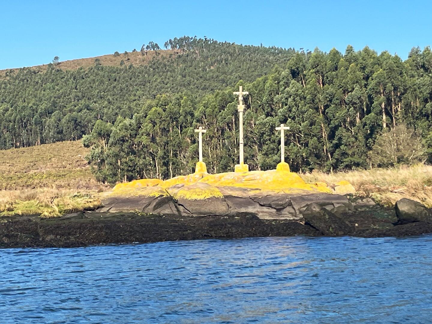The three crosses representing St. James (middle cross) and his disciples on either side.
