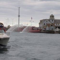 A fire tender in the Chicago River tests out its water cannon