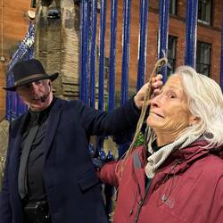 Cynthia playing a dead body during a grave robbing demo on Ghost tour in Glasgow