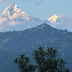 Glimpses of the Himalayas peek out from the clouds