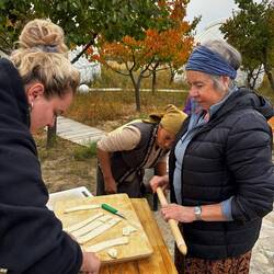 Our tour leader cuts the dough as Ann looks on