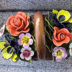 Beautiful old ceramic flowers on some graves.