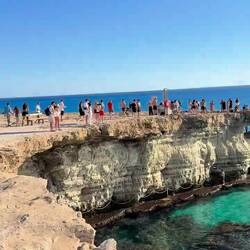 Bunch of brave kids jumping from the sea arches