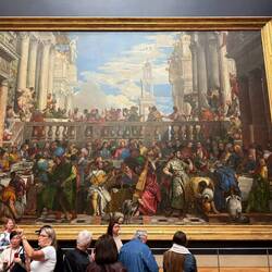 The Wedding at Cana by Paolo Veronese, painted 1463. This is huge and faces the Mona Lisa