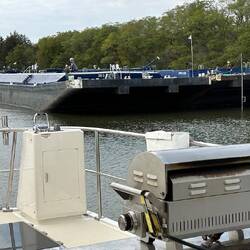 A tug and barge (known as a 'tow') departs the Marseilles Lock as we wait