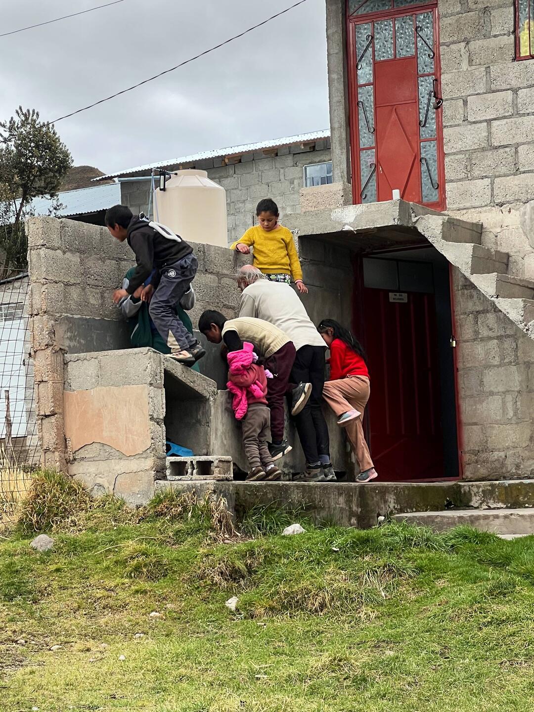 Village kids "helping" Alain with the water filter