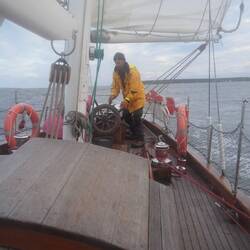 The crewman piloting the boat
