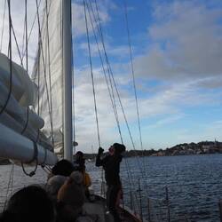 Volunteer crewman hoisting the mizzen sail