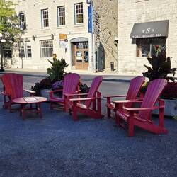 Red Adirondack chairs by the Ottawa sign