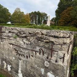Bunker damage and memorial in the background