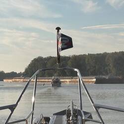 Flour Power and 45 North squeeze through between the channel markers and an upbound tow with 16 on