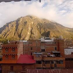 Sunrise on hills and new constructions from our hotel room in Huancavelica