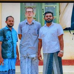 Aiden and teachers in sarong